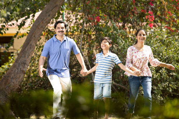 istock Happy family walking at park 1390427858