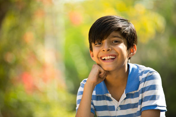 Cheerful boy looking away at the park