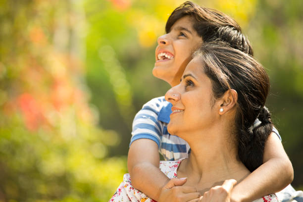 istock Mother and son admiring view at park 1390429695