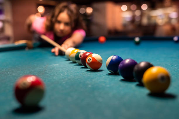 istock Pretty woman spend free time playing billiard snooker at pub 1390432071
