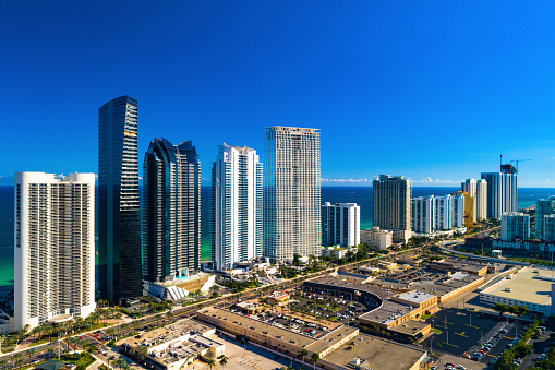 Aerial skyline view of beachside skyscrapers of Sunny Isles Beach in South Forida in the Miami Metropolitan Area, with the Atlantic Ocean in the background.