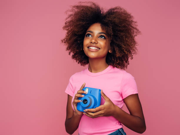 istock Happy beautiful woman with analog camera 1390433130