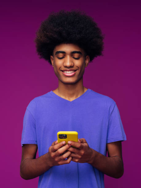 istock Portrait of funny afro guy using phone 1390433274