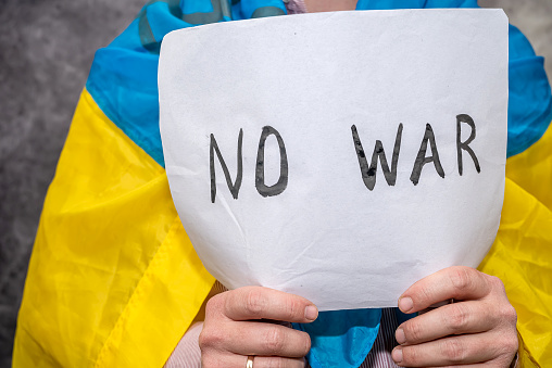 Man hold poster with text stop war in Ukraine,