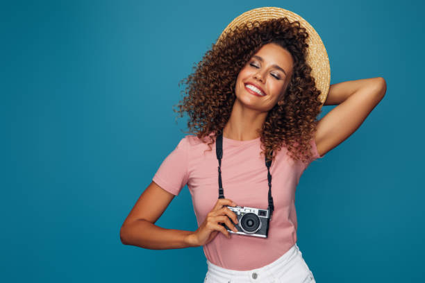 istock Happy beautiful woman with analog camera 1390433527
