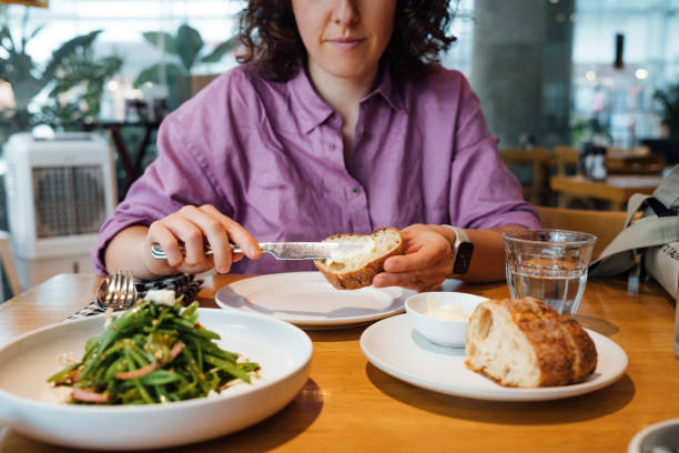 istock An Anonymous Female In Purple Shirt Smiling While Eating Breakfast In A Restaurant 1390439036