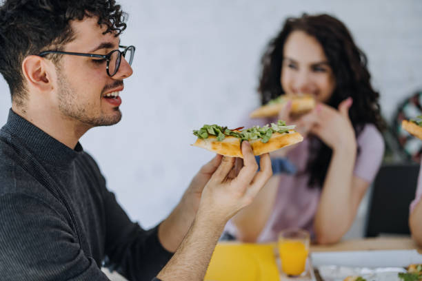 istock Students eat pizza in the apartment during the study break 1390440138