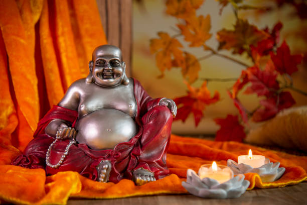 istock Buddha with candlelight and decoration on golden fabric - selective focus 1390440215