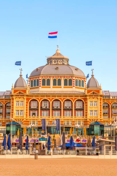 Scheveningen, Netherlands - April 7, 2016: Sunset on the beach, Grand Hotel Amrath Kurhaus near Hague, Holland