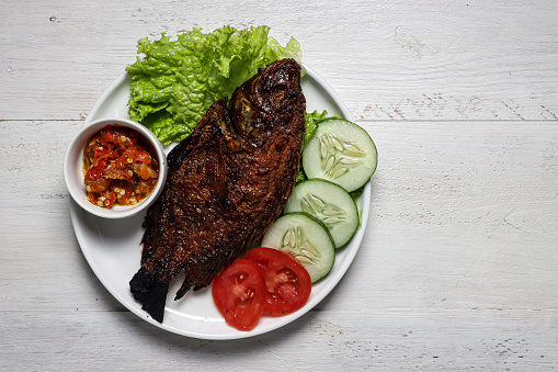 Tilapia Fish Grilled onion sauce, Indonesian traditional grilled nille tilapia fish with chilli garlic sauce.