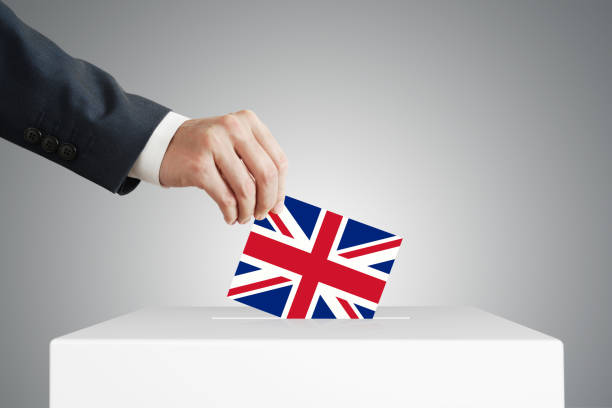 istock Man putting a ballot into a voting box. 1390443886