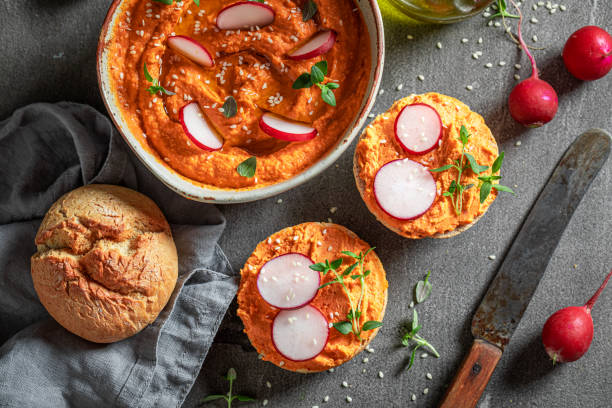 istock Traditional and delicious roll with tomato hummus, radish and herbs. 1390444839
