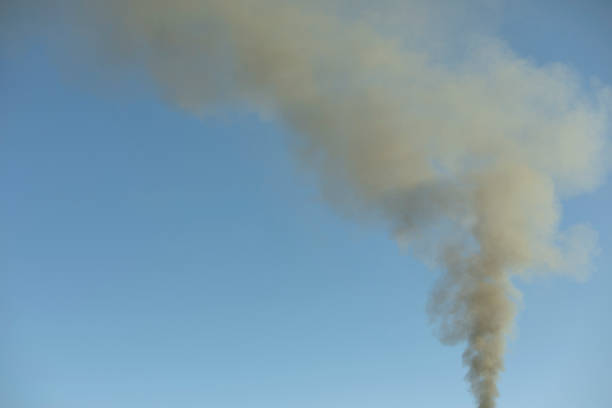 istock Smoke from chimney. Smoke in sky. Home heating. 1390447265