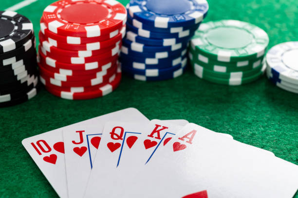 istock Royal flush and gambling chips on gambling table 1390448605