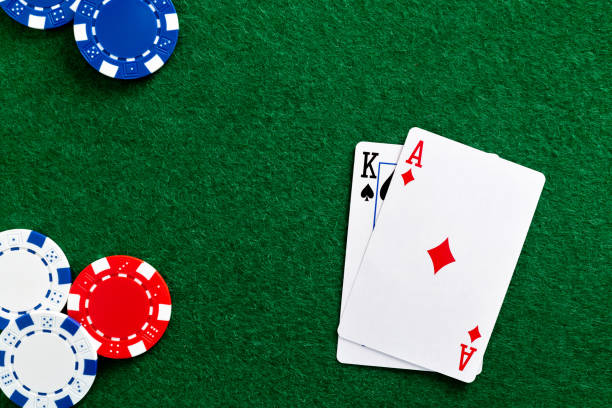 istock Playing cards and gambling chip on the table 1390449201