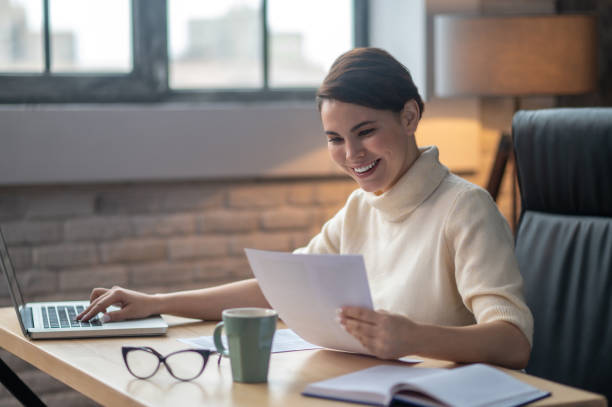 istock A woman sitting at the table in the office and working 1390449514