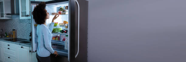 istock Woman Searching Food In Refrigerator 1390450610