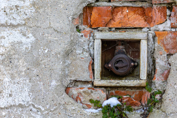 istock Old electrical on-off switch on the outside wall of the building. 1390450621