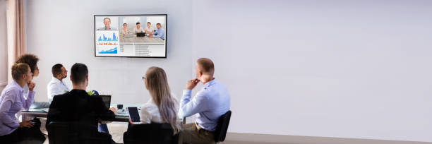 istock Businesspeople Video Conferencing In Boardroom 1390450625