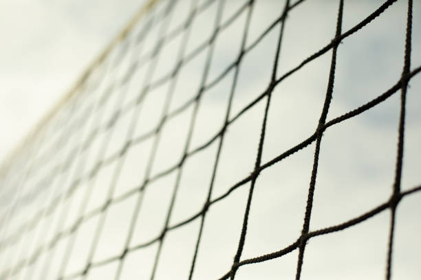istock Sports net. Volleyball equipment. Grid against sky. 1390451041