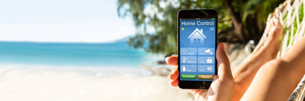istock Woman Using Smart Home On Mobile Phone At Beach 1390452401