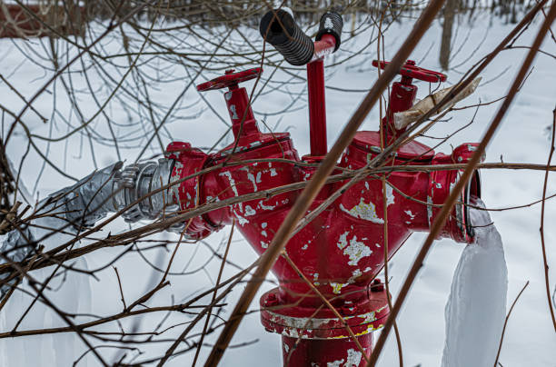 red fire hydrant V - shaped with frozen water jet