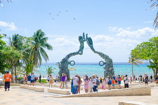 Crowd at Parque Los fundadores with siren statues at Playa del Carmen during day of march