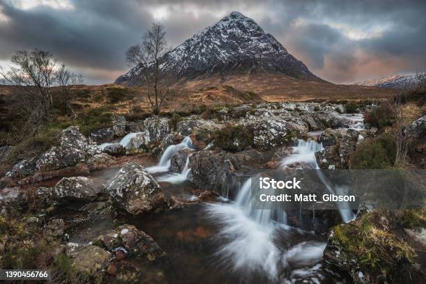 Epic Majestic Winter Sunset Landscape Of Stob Dearg Buachaille Etive Mor Iconic Peak In Scottish Highlands With Famous River Etive Waterfalls In Foreground Stock Photo - Download Image Now