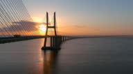 istock Aerial view of the Vasco da Gama bridge in Lisbon at dawn and trafic all around that passes by 1390462120