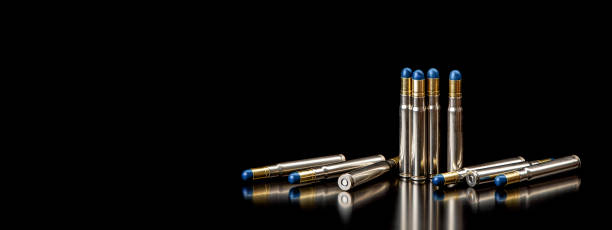 istock Bullet isolated on black background with reflexion. Rifle bullets close-up on black back. Cartridges for rifle and carbine on a black. 1390464860