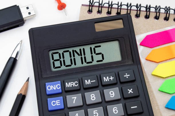 istock Word BONUS on the display of a calculator on financial documents 1390466041