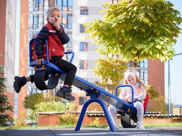 istock Cheerful brother and sister having fun at playground. 1390467637