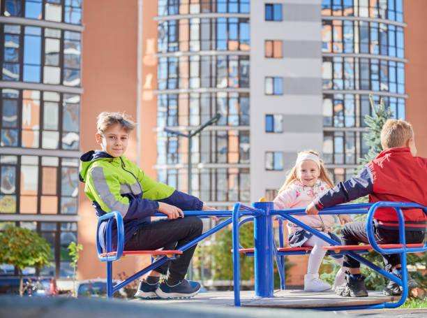 istock Cheerful brother and sister having fun at playground. 1390468185