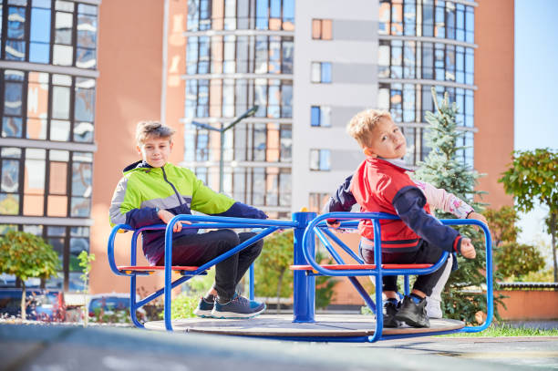 istock Cheerful brother and sister having fun at playground. 1390468192