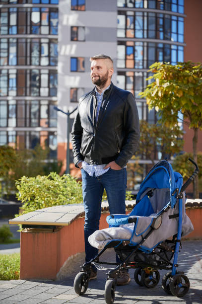 istock Father spending time with newborn kid outdoors. 1390468340