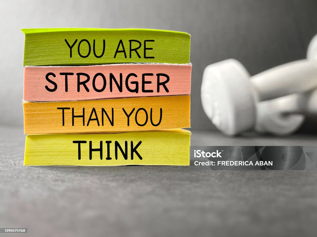 Inspirational and Motivational Quote Inspirational and motivational quote concept. You are stronger than you think text on notepaper background. Inspirational Quote Stock Photo