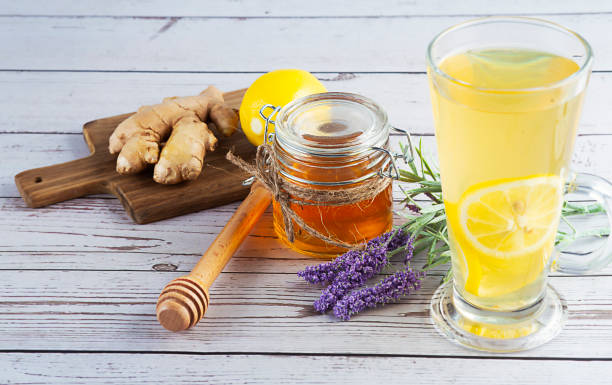 istock A glass cup of tea with lemon, ginger and honey on rustic table. 1390475508