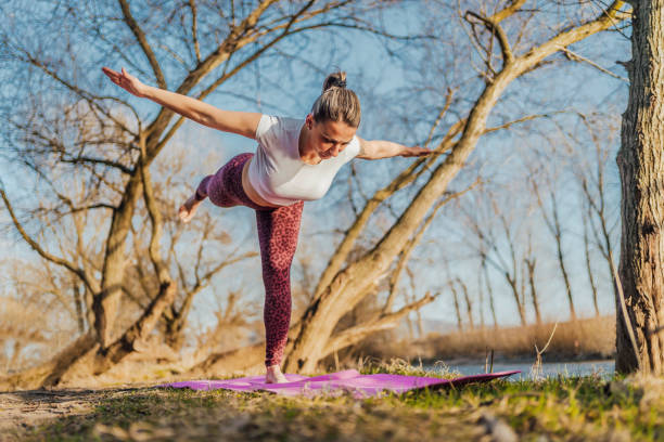 istock Woman practicing yoga in nature 1390477645