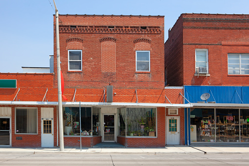 Small businesses in red brick buildings on Main St. in Staunton, Illinois, a typical small town in the American midwest.