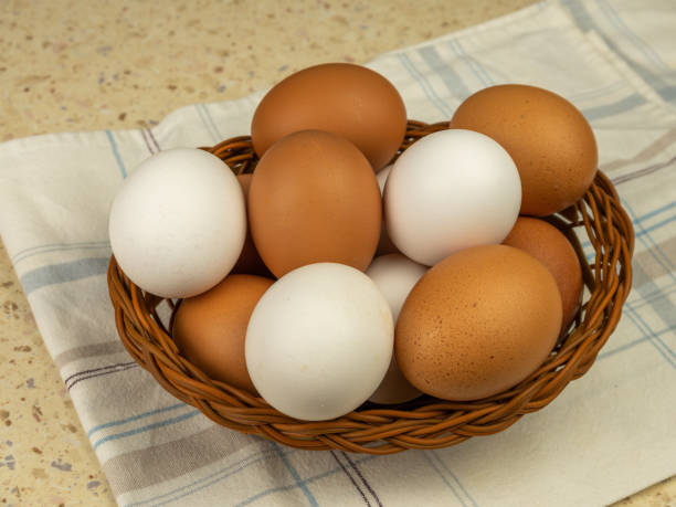 istock Fresh eggs in wicker basket on wood table. Close-up. Copy space. 1390480608