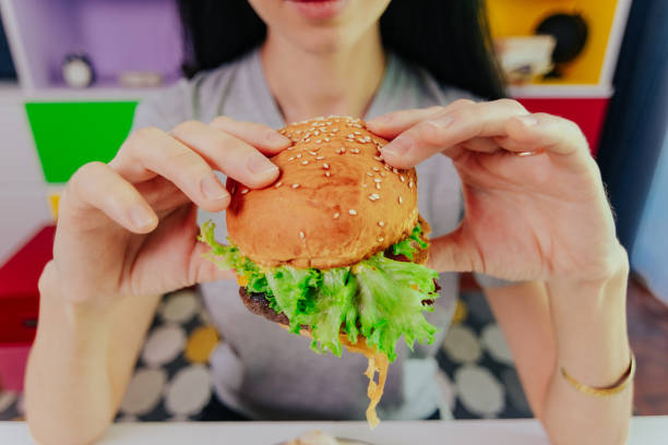 istock Woman enjoy her cheer burger, POV. 1390481885