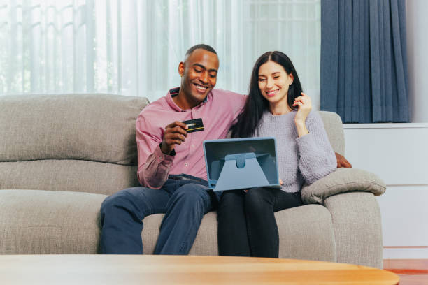 istock Happy couple doing online shopping using digital tablet. 1390482044