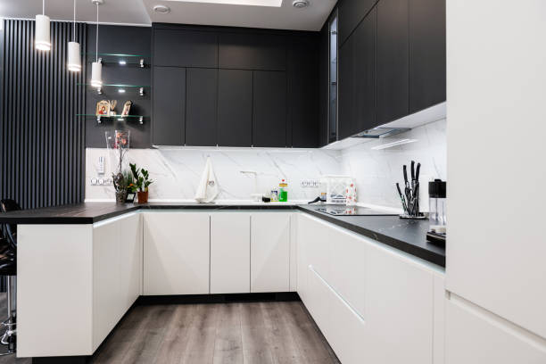 istock Stylish, corner kitchen with a table in black and white 1390482202