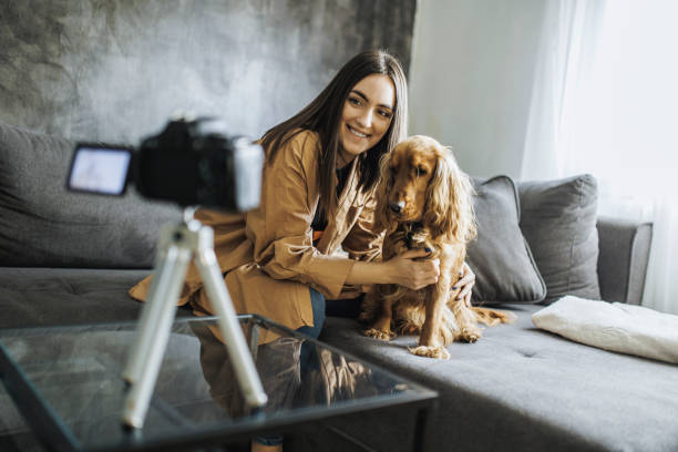 istock Woman and her dog Cocker Spaniel taking a selfie by camera 1390485760