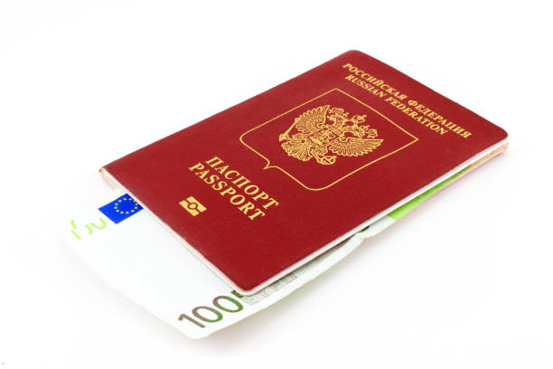 istock passport and money on a white background 1390489518