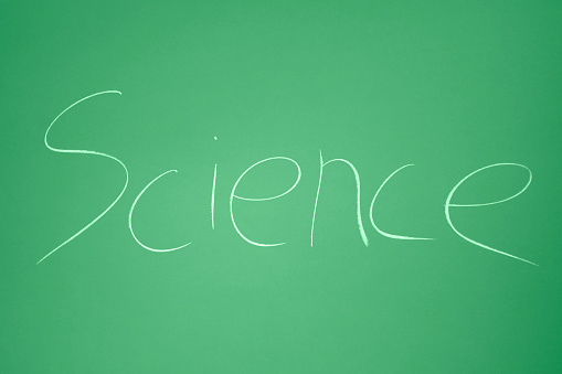 The world Science written in chalk on a classic green chalkboard.
