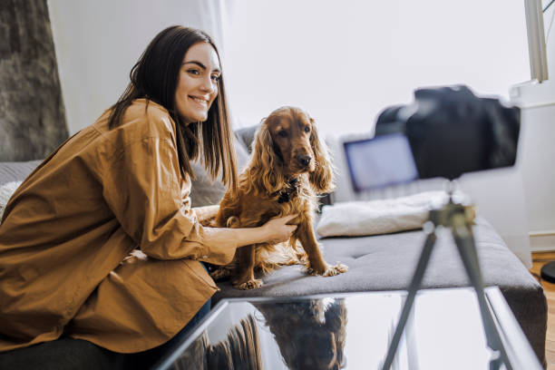istock Woman and her dog Cocker Spaniel taking a selfie by camera 1390489876