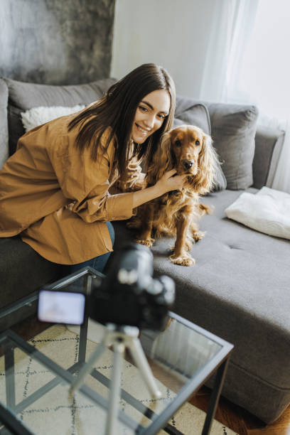 istock Woman and her dog Cocker Spaniel taking a selfie by camera 1390489944
