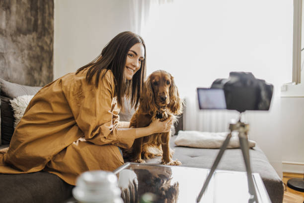 istock Woman and her dog Cocker Spaniel taking a selfie by camera 1390489967