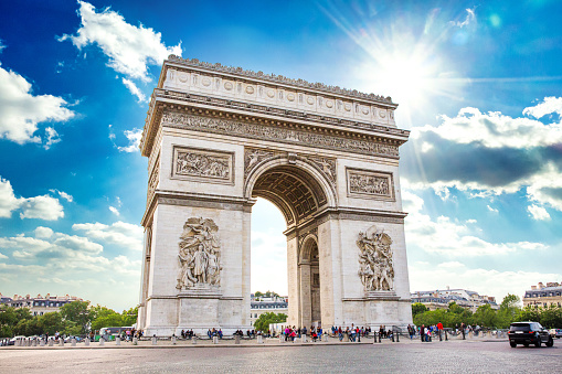 The Arc de Triomphe in Paris France on a bright summer day.